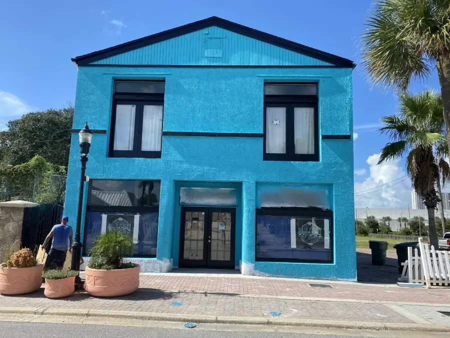 A freshly painted blue commercial building